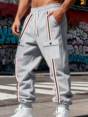 Front view of gray joggers with contrast stripes and flap pockets