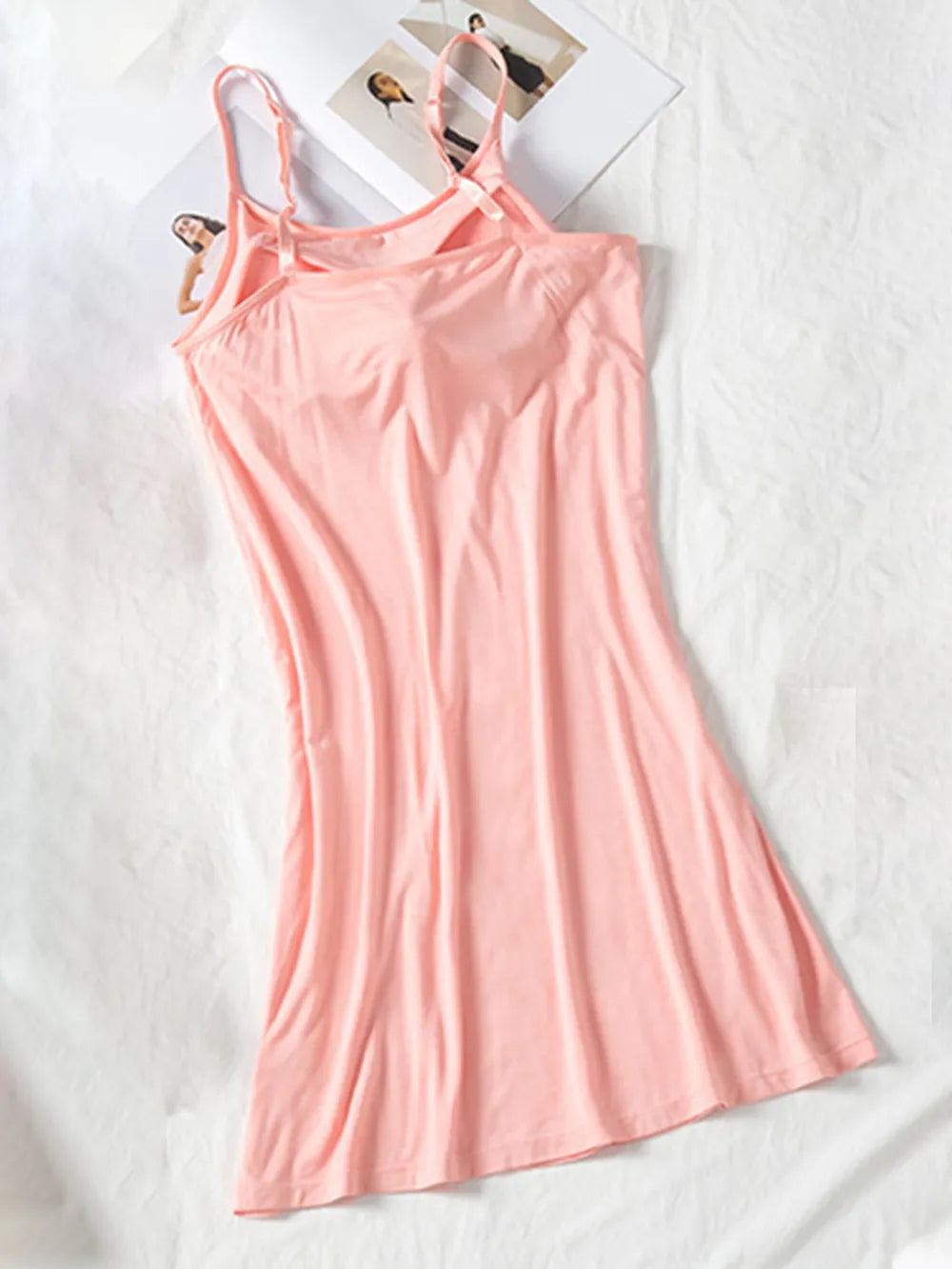 Blush pink cami dress shown full length with slim straps and gently flared skirt