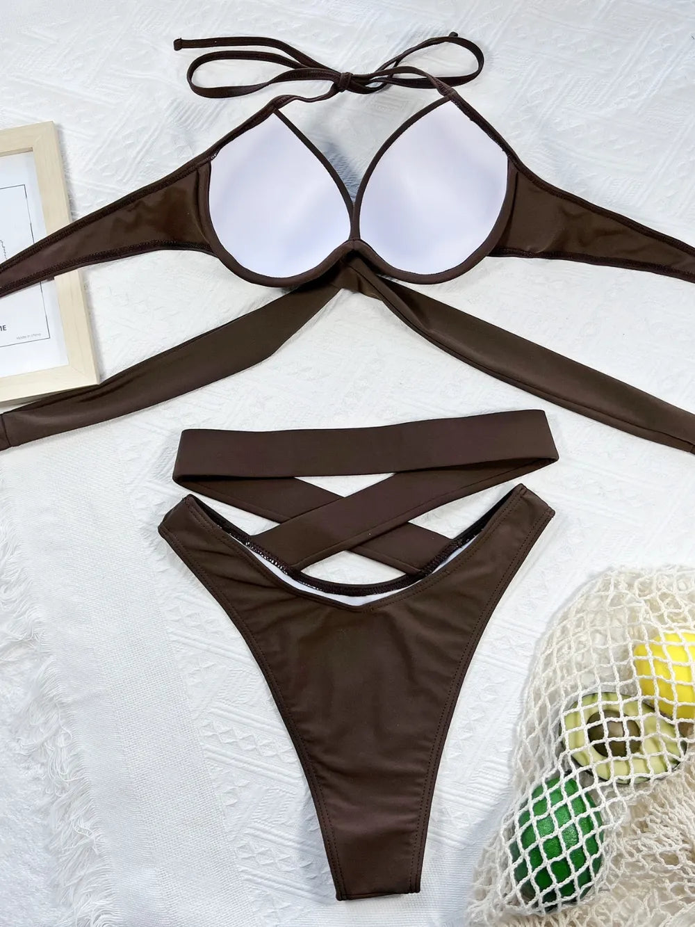 Inside of brown bikini top showing white cup lining