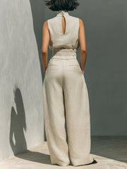 Back view of the cream turtleneck top and matching wide-leg trousers.