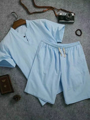 Light blue short-sleeve two-button shirt and matching drawstring shorts laid flat