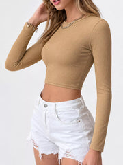 Tan long-sleeve cropped top shown from the front