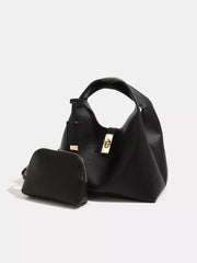 Black pebbled turn-lock handbag with a small matching zip pouch