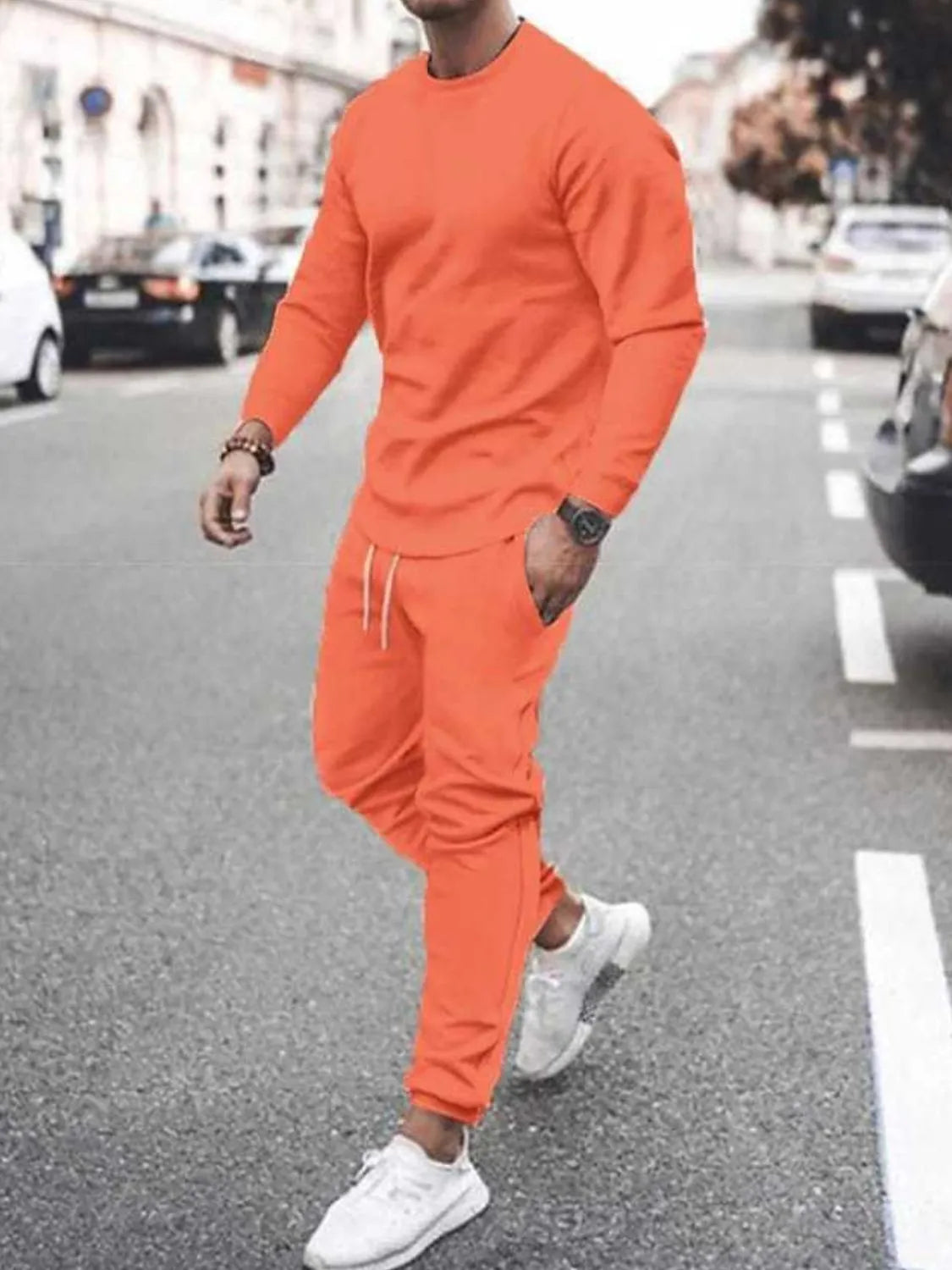 Model wearing orange long-sleeve top and jogger pants set