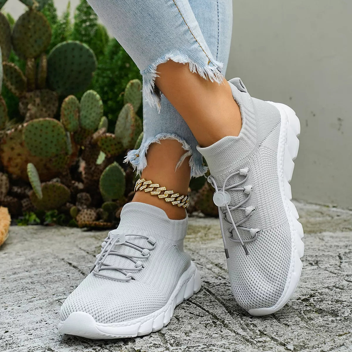 Black sneakers shown from front