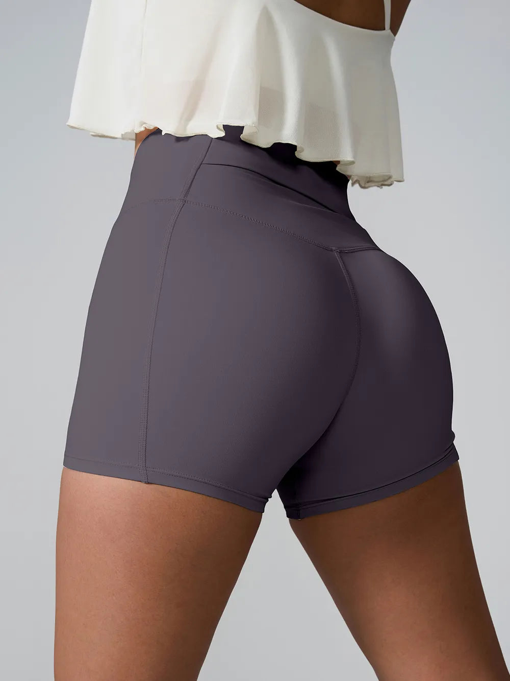 Side view of plum high-waist shorts with a contoured waistband.