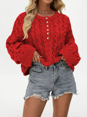 Women’s cable-knit half-button openwork sweater in red front pose with hand at hip