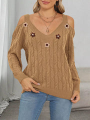 Tan cable-knit sweater with pink and brown floral appliqués, front view