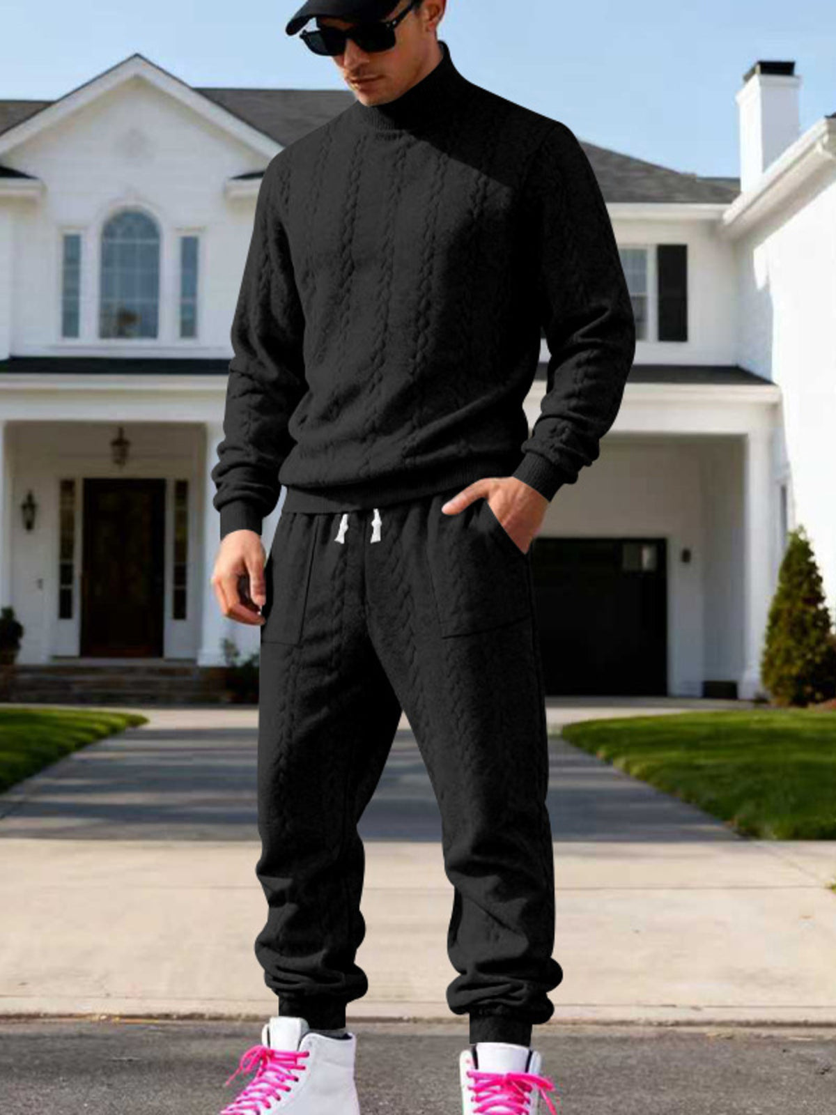 Black cable-knit mock-neck sweater and joggers worn front-facing.