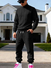 Black cable-knit mock-neck sweater and joggers worn front-facing.