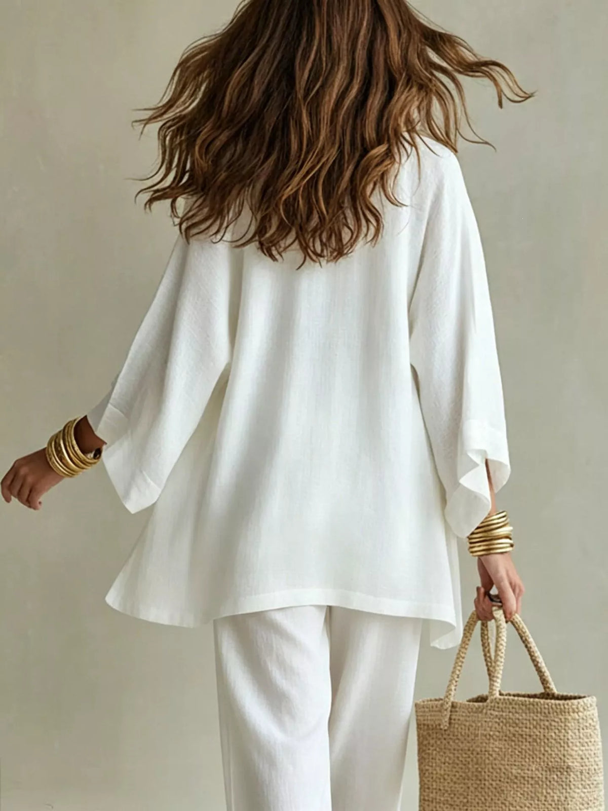 Back view of the ivory outfit showing the loose cardigan over matching pants.