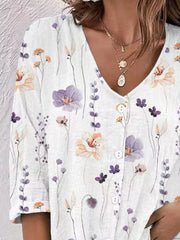 Detail view of white floral blouse front and buttons.