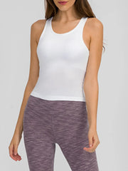 Model wearing black ribbed racerback tank with plum leggings