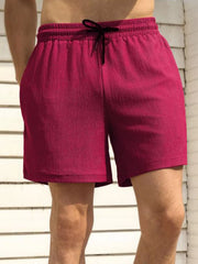 Model wearing magenta drawstring shorts, front view