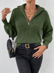 Front view of green ribbed quarter-zip sweater on a model with black jeans