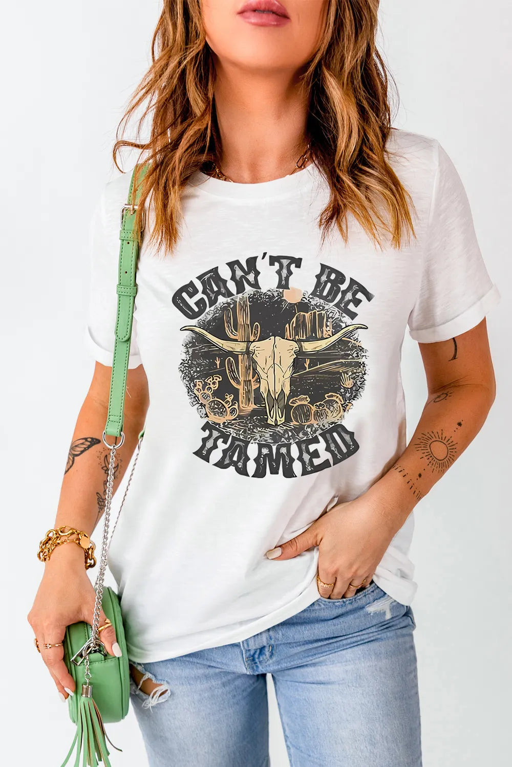 Model wearing white Cant Be Tamed graphic T-shirt, front view