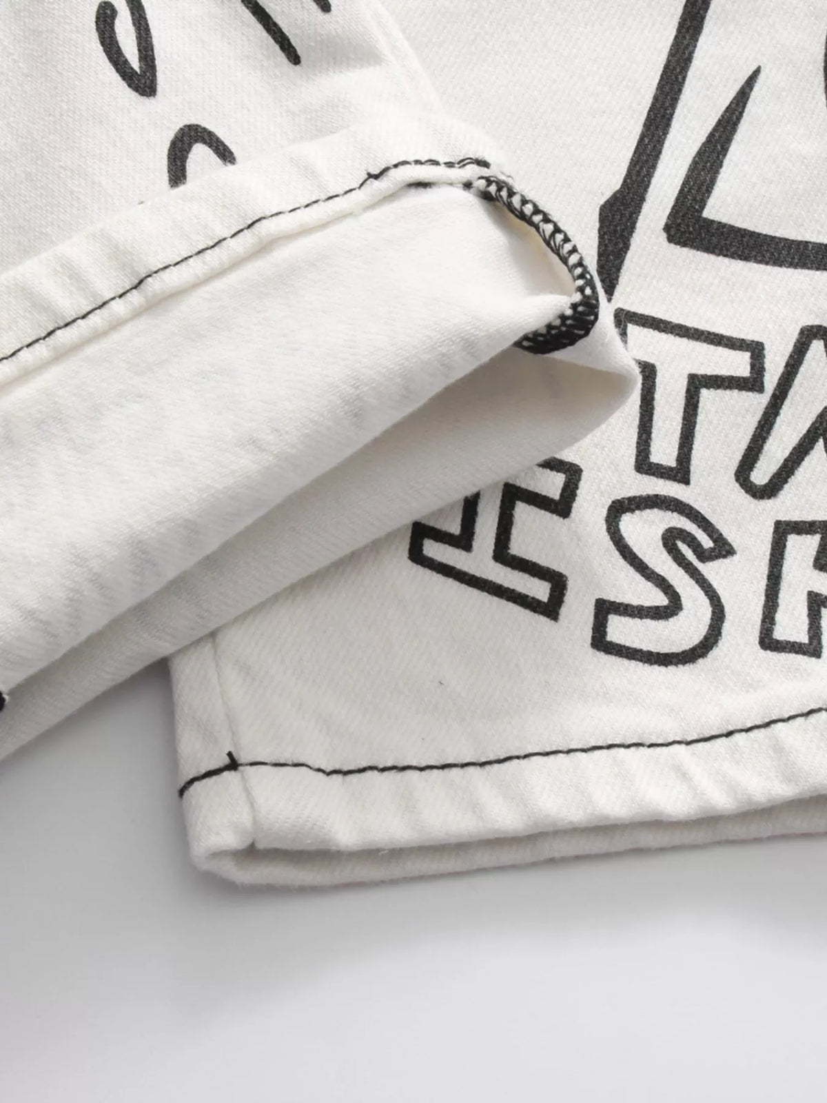 Close-up of folded edge and printed white denim