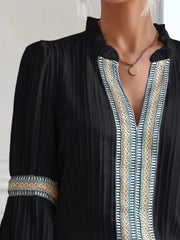 Notched textured balloon-sleeve blouse in black close front view