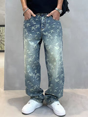 Front view of blue bird-print jeans with hands in the pockets