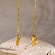 Close-up of the oval pendant and fine gold chain