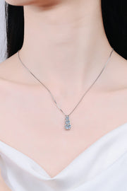Model wearing a delicate vertical three-stone pendant necklace