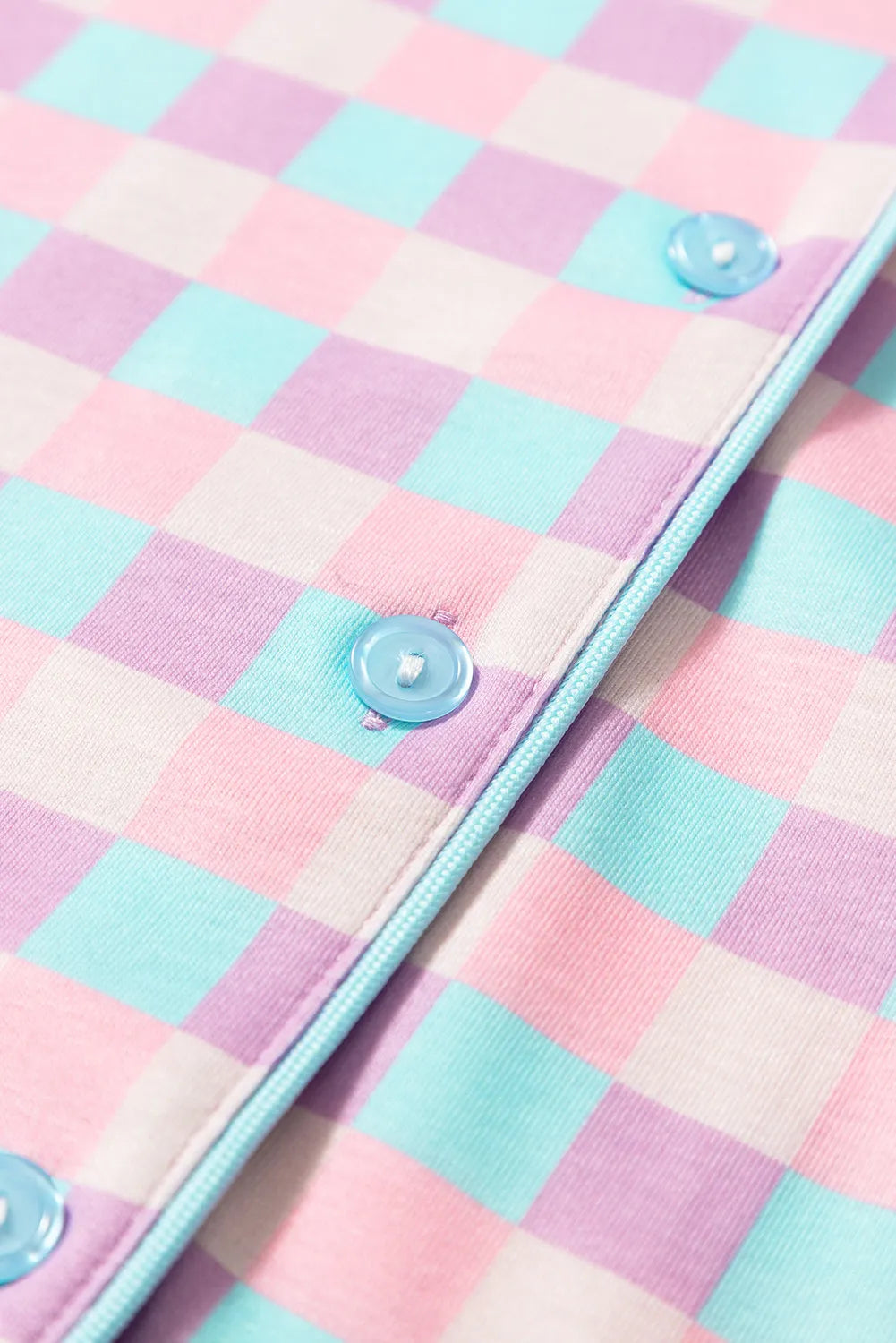 Detail of pink and blue checked lounge shirt sleeve and piped cuff