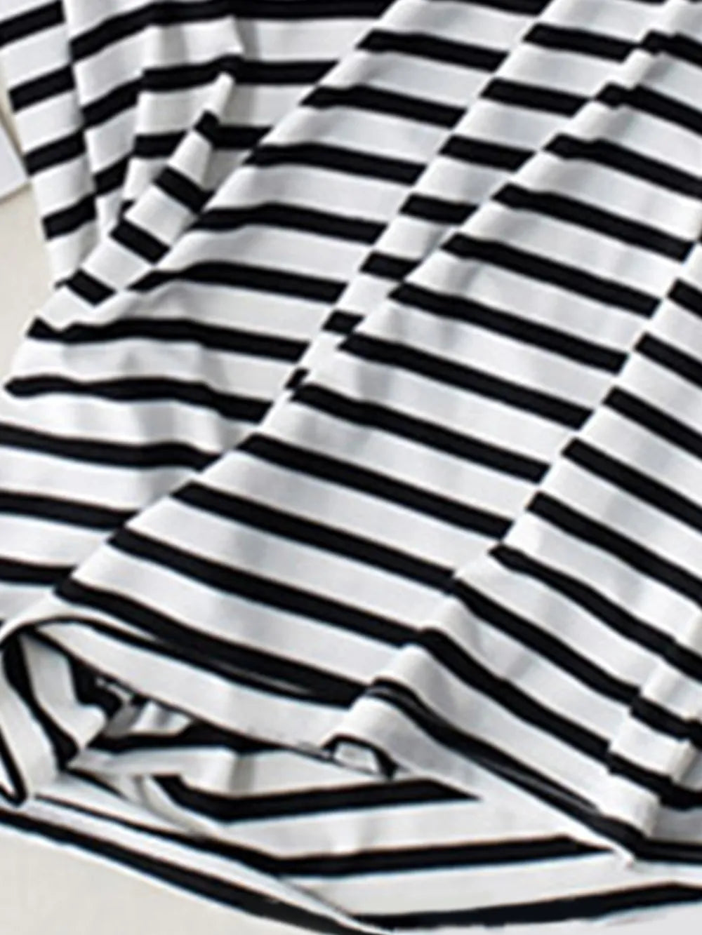 Black-and-white striped shirt detail showing built-in bra lining