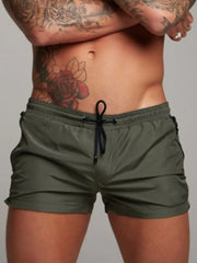 Model wearing olive gray drawstring active shorts