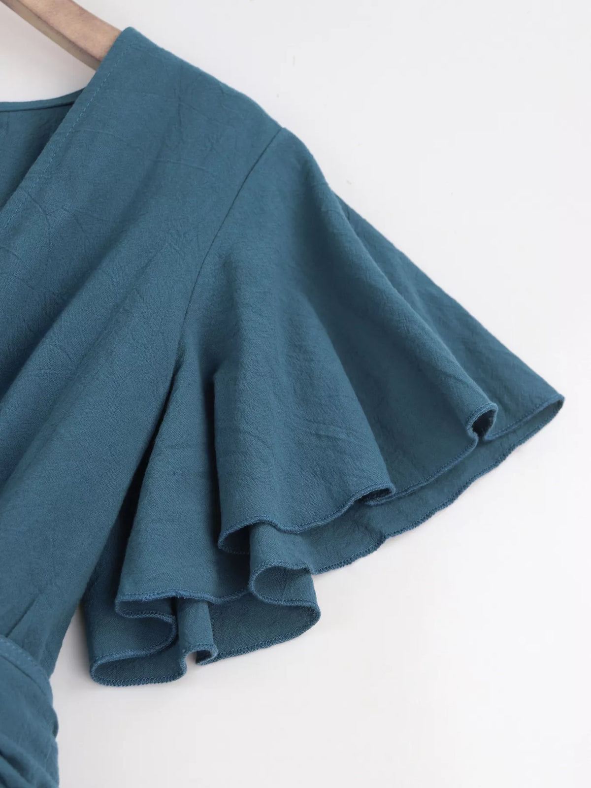 Close-up of haze blue flutter sleeve