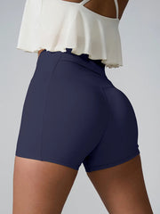 Side view of deep navy fitted shorts with a high-rise waistband.