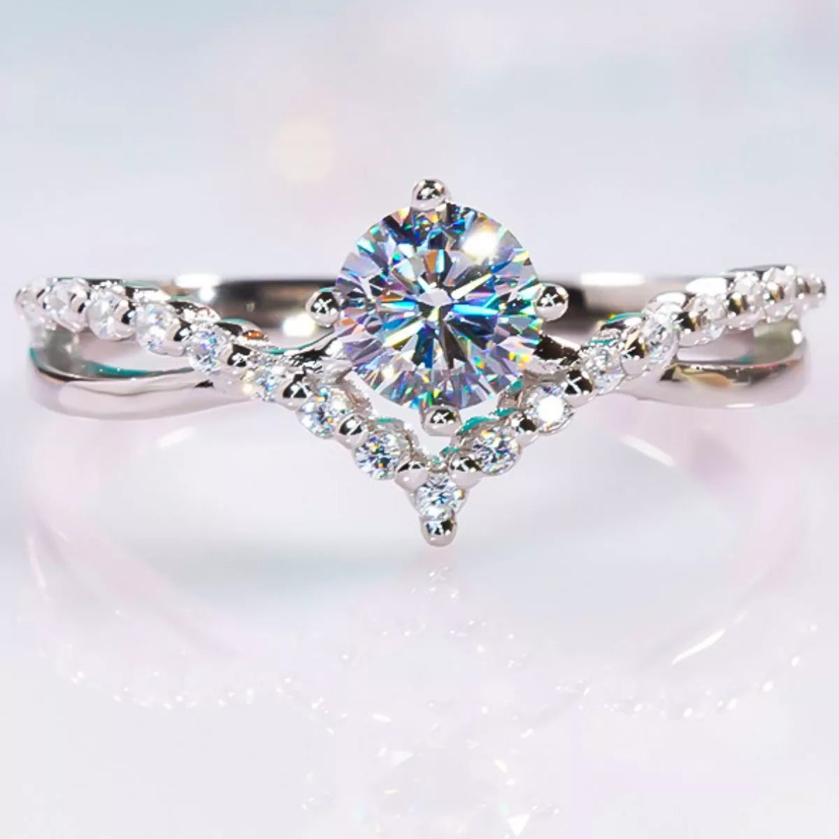Blue rectangular center stone on a slim pavé band, viewed from above on a hand.