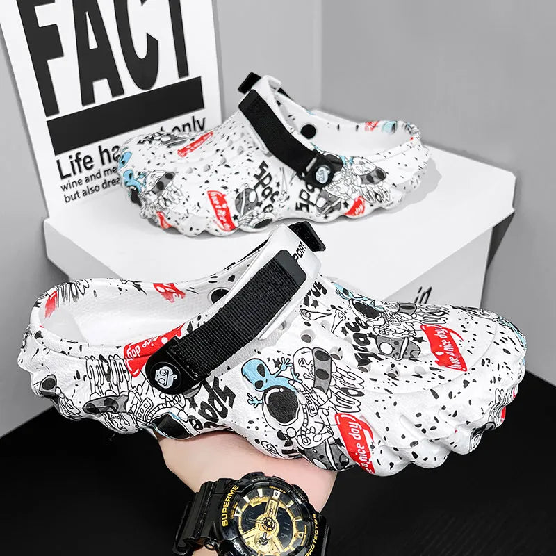 White graffiti-print clogs with black instep straps, one held above a display block