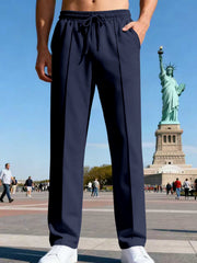 Front view of navy straight-leg drawstring pants near the Statue of Liberty.