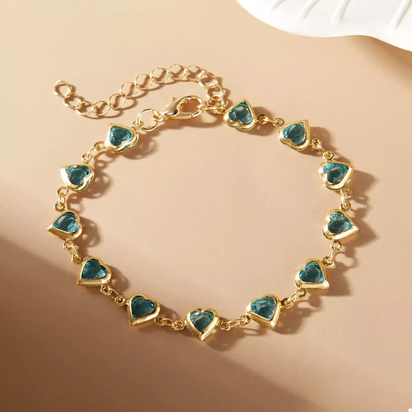 Gold heart bracelet displayed flat