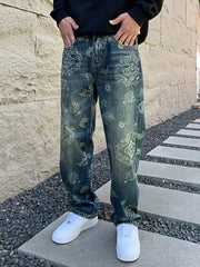 Front view of men's loose blue jeans with faded ornamental and floral patterns