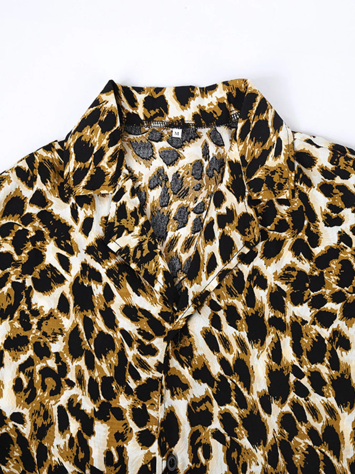 Close-up of the leopard-print shirt collar and buttons