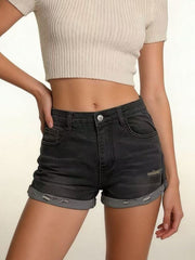 Model wearing black denim roll-up shorts with cuffed hems