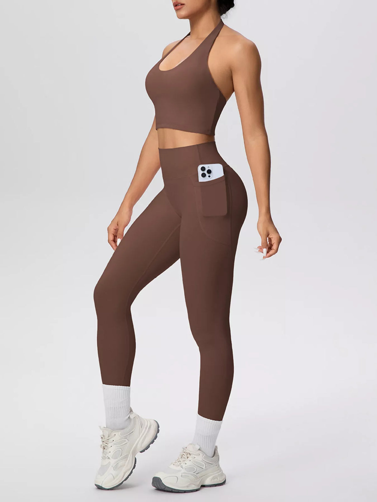 Side view of brown halter set with phone pocket on leggings