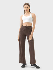 Model wearing brown active pants with drawstring waist