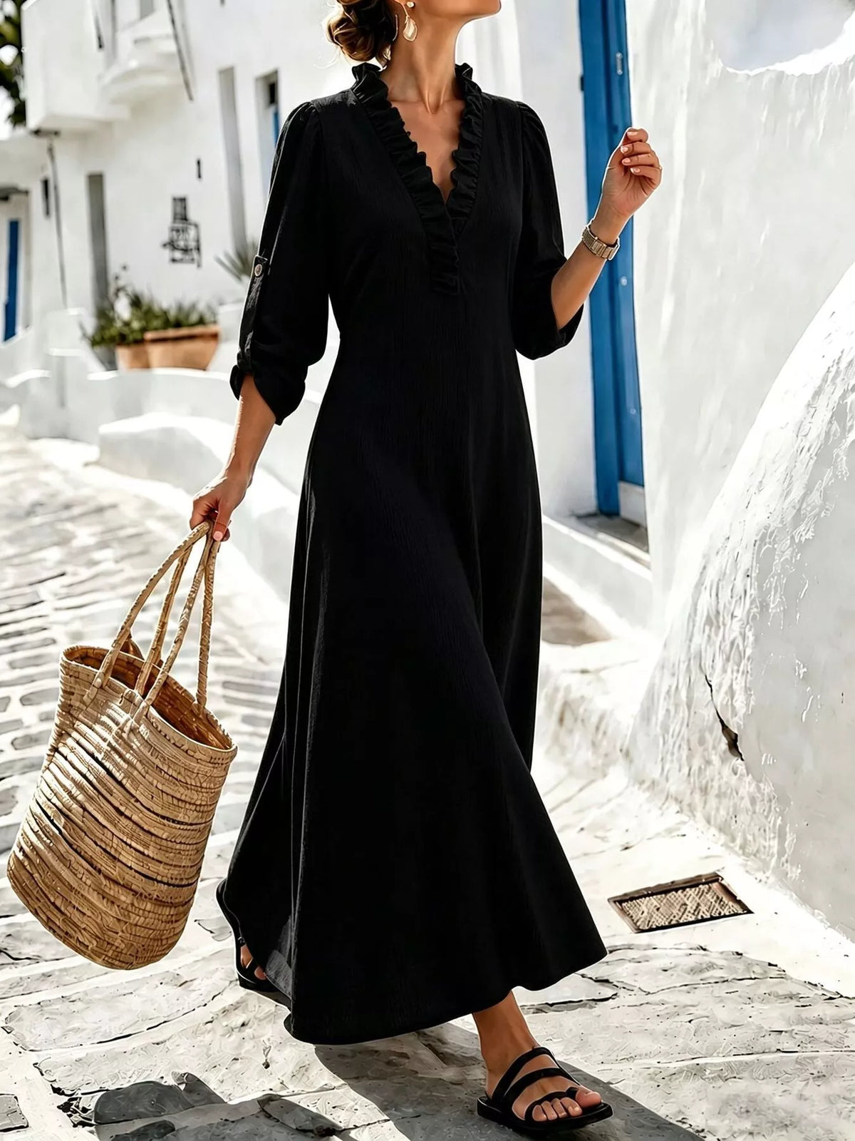 Black V-neck maxi dress styled with woven tote
