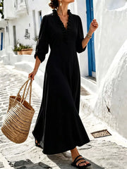 Black V-neck maxi dress styled with woven tote