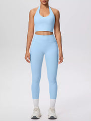 Side pose in pale blue halter set with hand in pocket