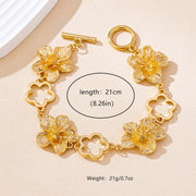 Gold-tone floral link bracelet with chain length text