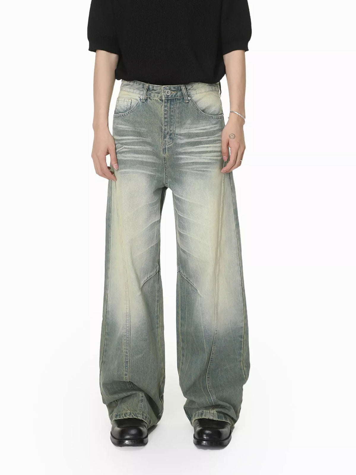 Front view of light-wash wide-leg jeans worn with a black top