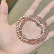 Close view of pink and white beads in the two-piece bracelet set