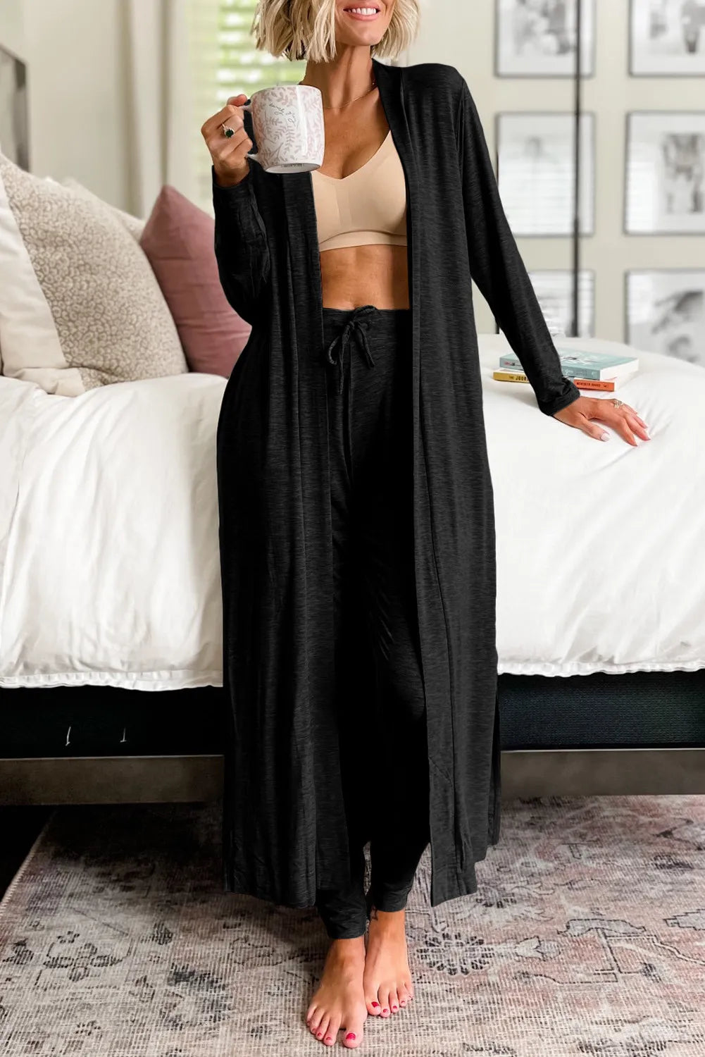 Model wearing black open-front cardigan over a light top with black lounge pants