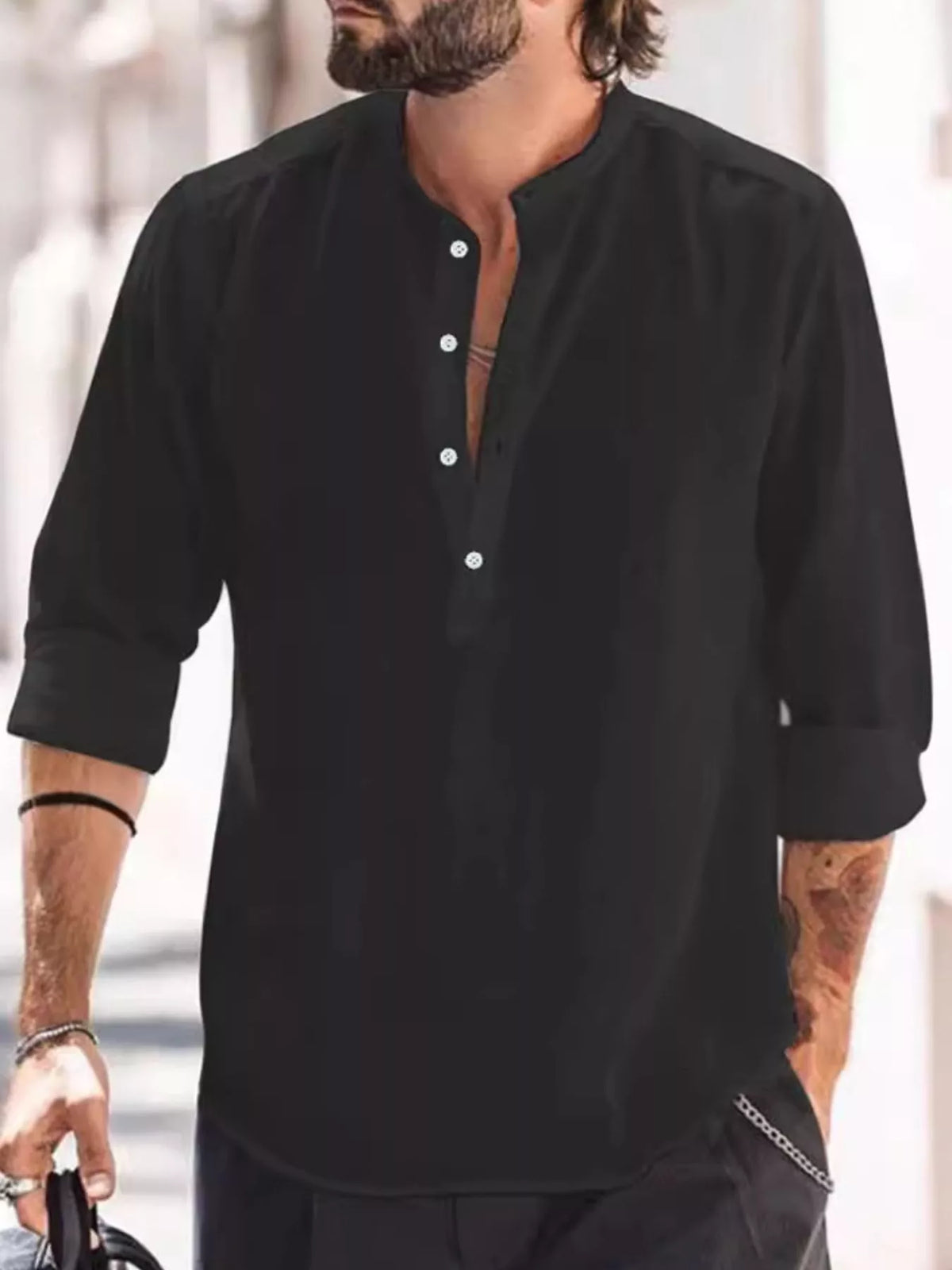 Model wearing a black long-sleeve shirt with a short button placket
