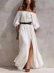 Model wearing white off-shoulder maxi dress with black belt and side slit