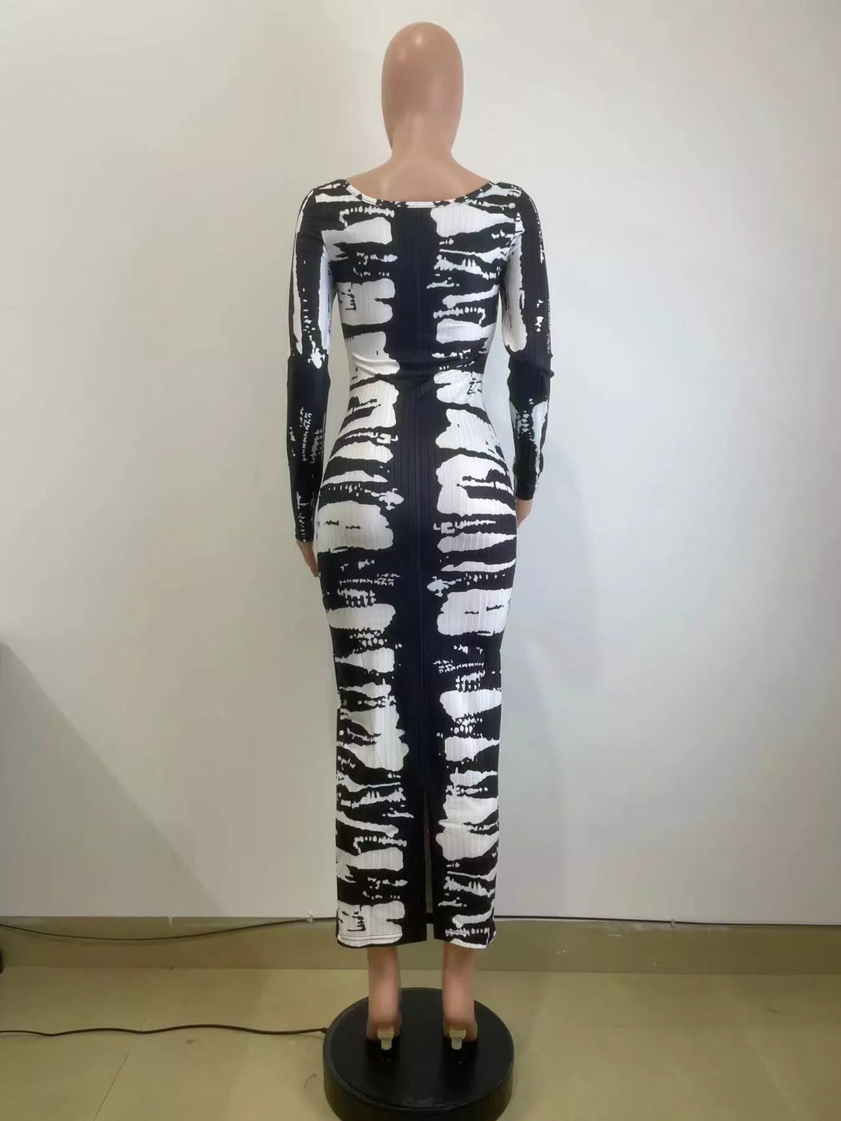 Back mannequin view of black and white tie-dye long-sleeve dress