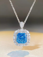 Blue rectangular pendant necklace with clear stone border and silver-tone chain, front view